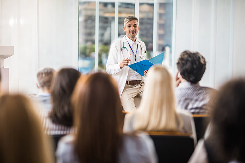 a doctor lecturing in front of students