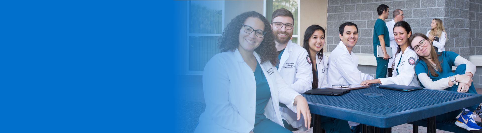 group of healthcare students sitting at a picnic table outside