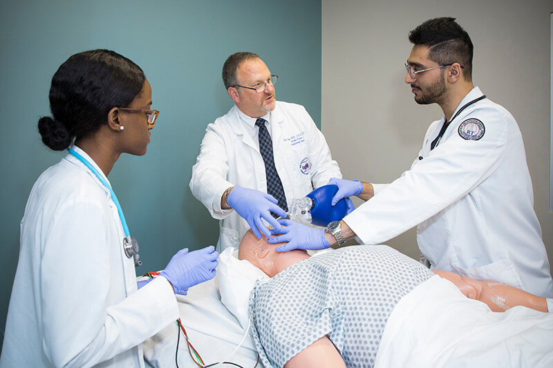 Health professionals practicing on a medical dummy